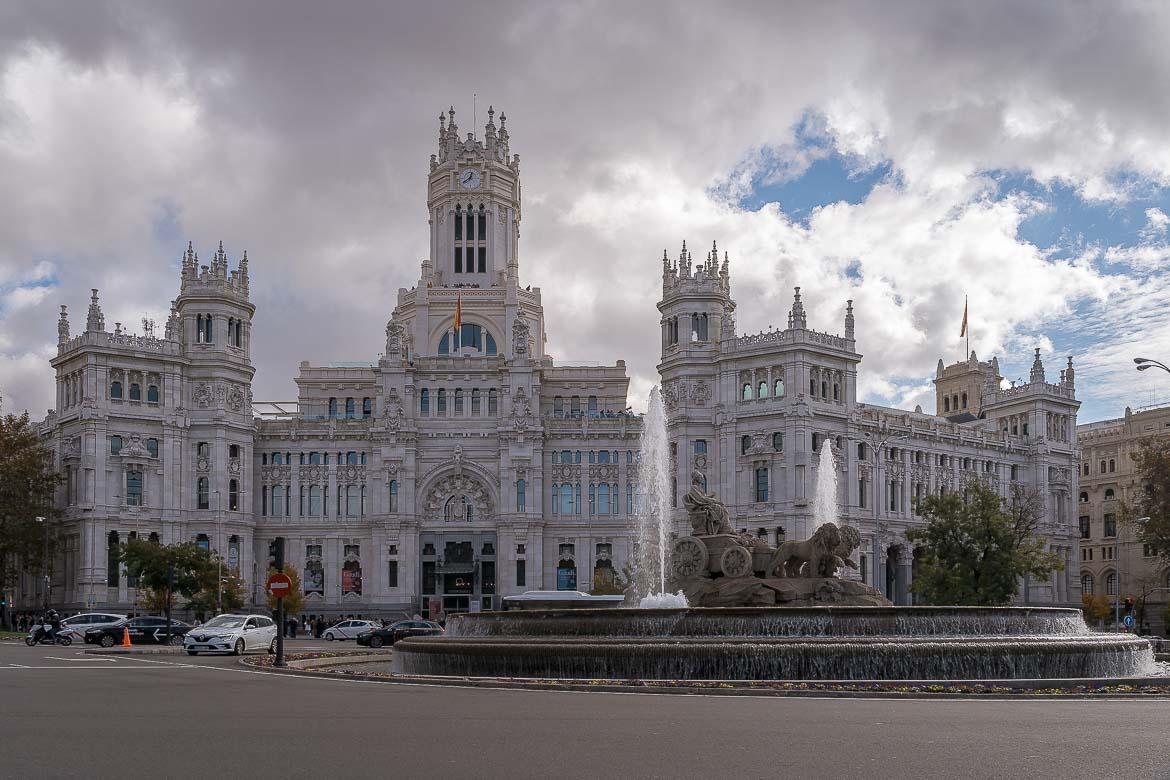 This image shows Palacio de Cibeles with the fountain of Plaza de Cibeles in the foreground.