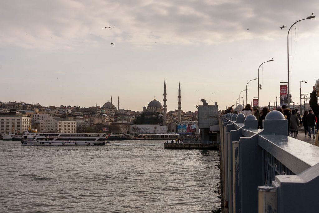 Best places to stay in Istanbul: neighbourhoods & hotels This is a photo of the Galata Bridge in Istanbul during sunset. It is the featured image on our article entitled Best places to stay in Istanbul: neighbourhoods & hotels.