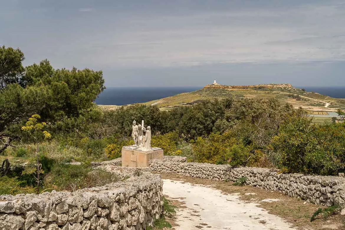 One of the marble statues on the uphill way to Ghammar Hill. The lighthouse can be seen in the background.