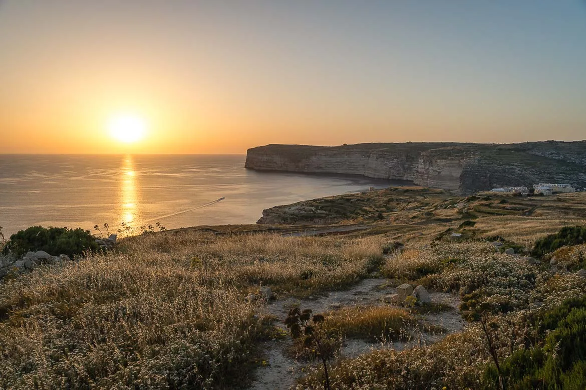 Panoramic view of Sanap Cliffs from the sunset viewpoint. The sun is about to set above the sea.