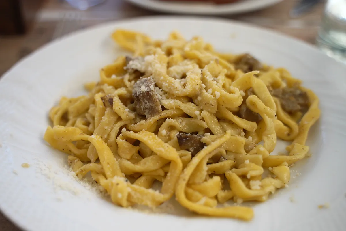 A close-up of a pasta with artichokes dish.