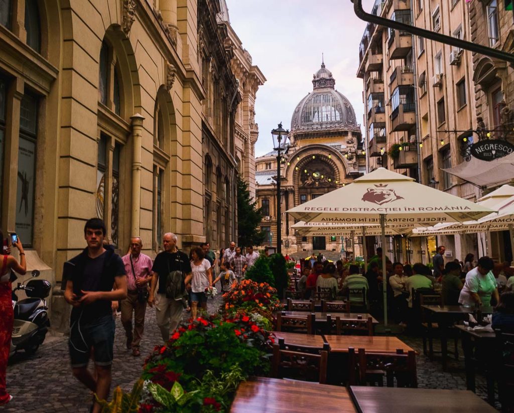 This photo shows the outside seating area of Caru' cu Bere restaurant in the old town. Dining there is considered one of the top things to do in Bucharest, Romania.