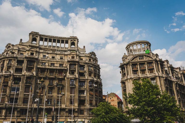 This photo shows two buildings typical of the Ceausescu era architecture. Bucharest walking tour of Communism, Romania.