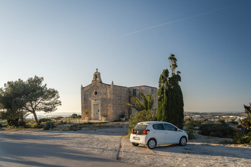 Driving in Malta, Car Rental Tips & Suggested Road Trip Our rental car outside a chapel near Victoria Lines.