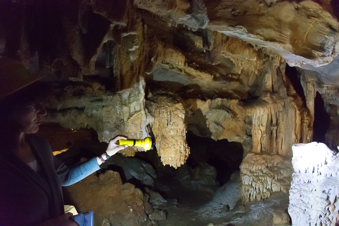 This image shows our guide inside Foros Cave shedding light with her torch at some rock formations she wants us to see. 