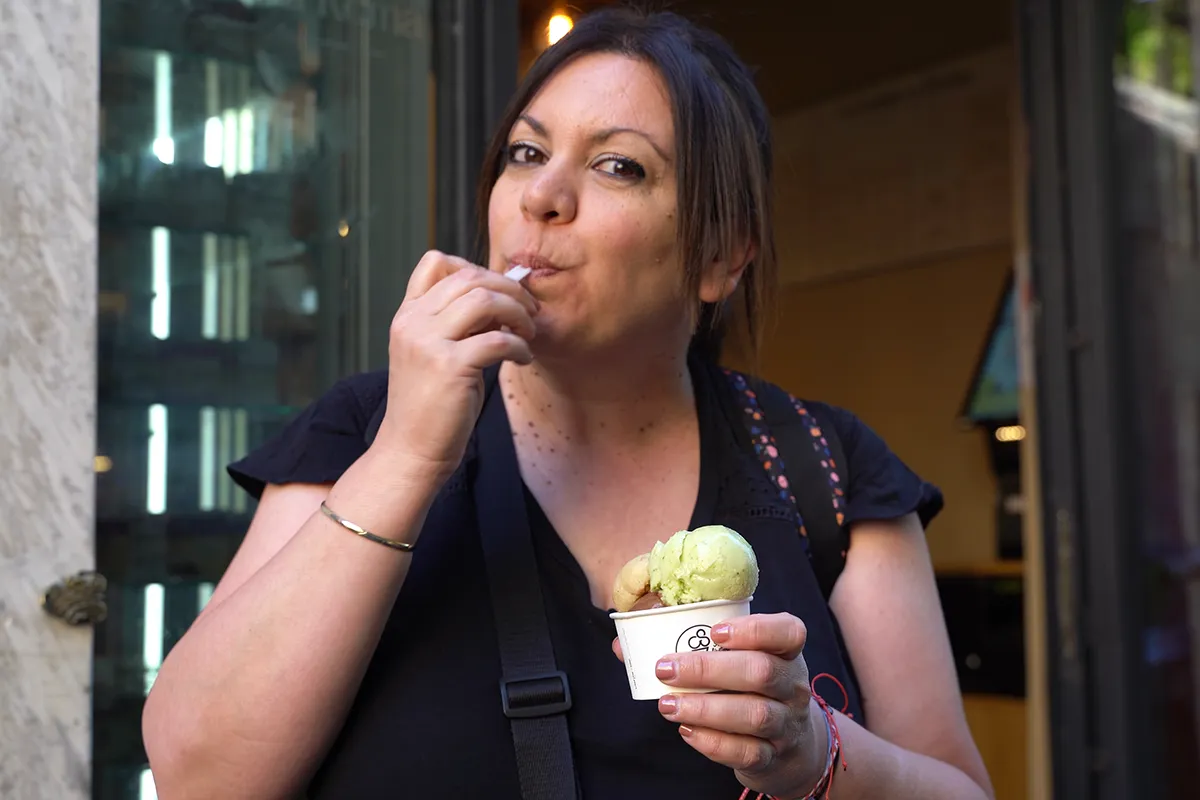 Maria enjoying a cup of gelato outside a gelateria.