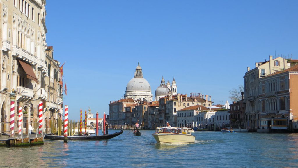 This photo shows the canal grande or grand canal in Venice. A venice boat tour is one of the top things to do in Venice Italy.