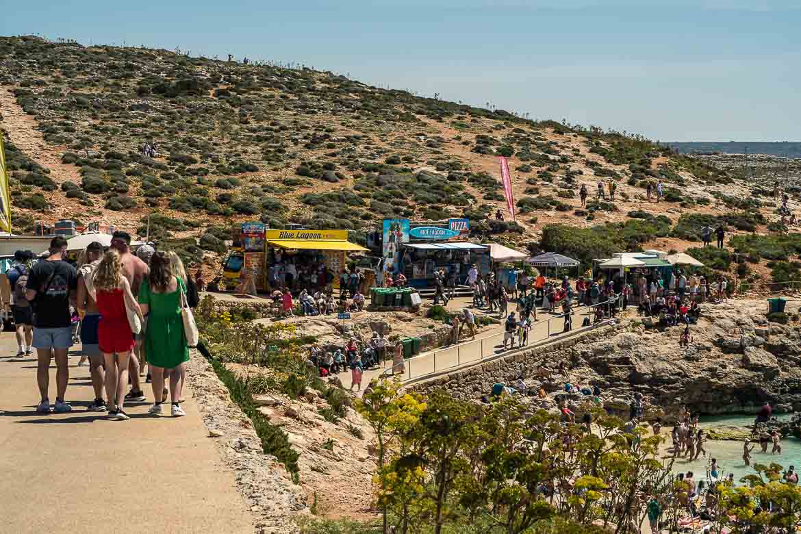 This image shows the food trucks and the crowds on Comino Island.