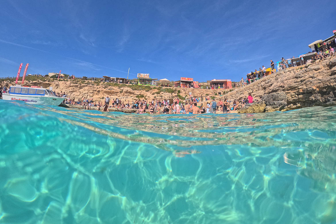 This image shows the view of Blue Lagoon and the shore of Comino from the water.