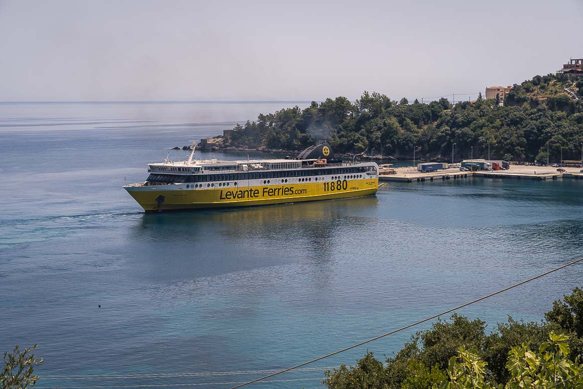 The ferry coming from Kyllini arrives at Poros port. The yellow-white ferry has Levante Ferries written on it in black letters.