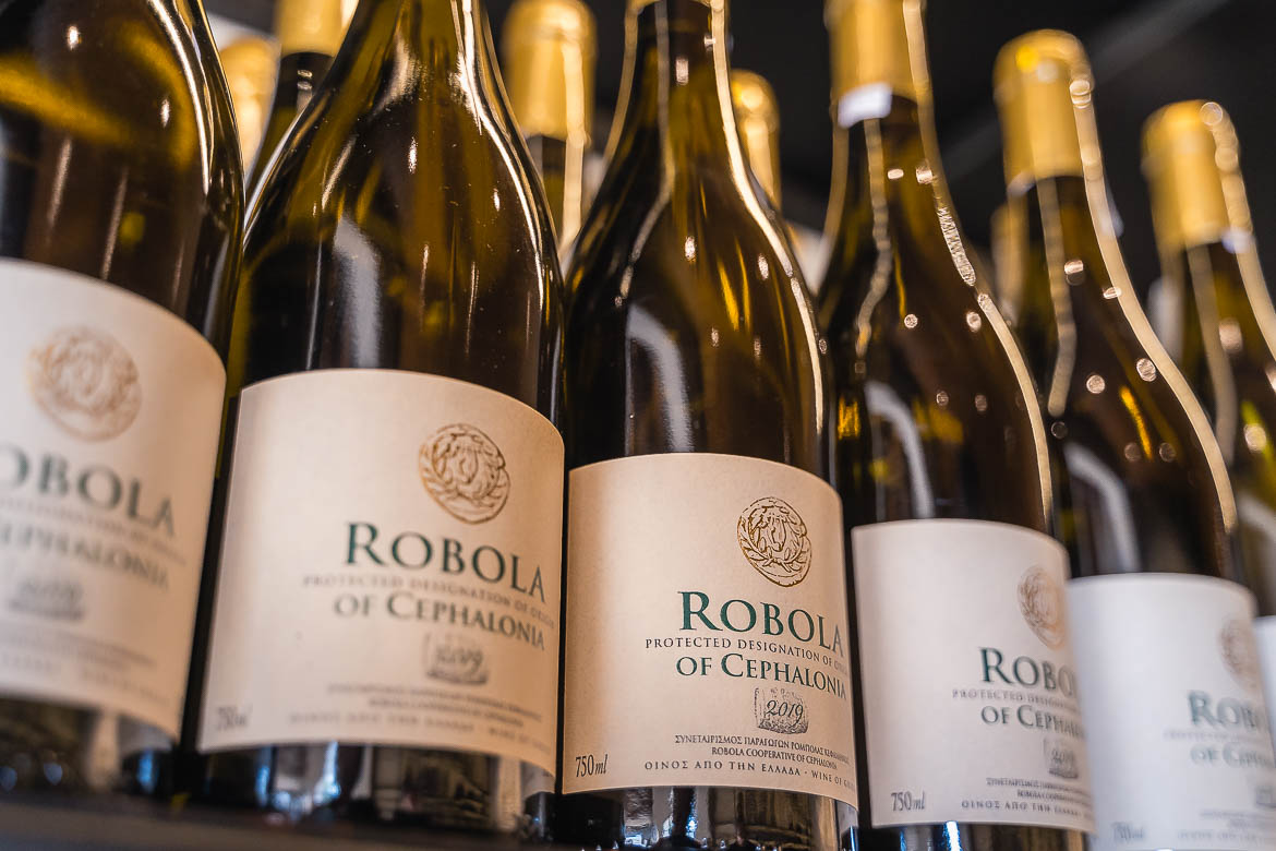 Bottles of Robola wine on a shelf.