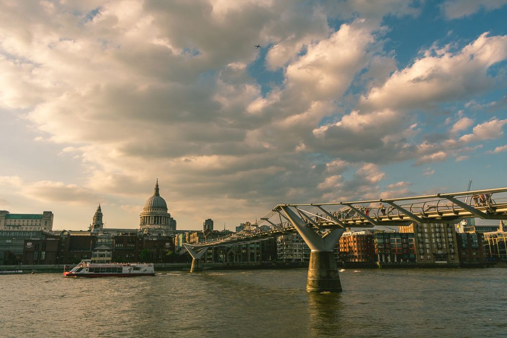 This photo shows the Millennium bridge in London, England, as well as St Paul's Cathedral. South Bank walk.