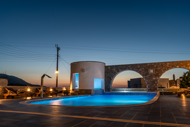 This image shows the swimming pool area of Vigla Hotel Amorgos at dusk.