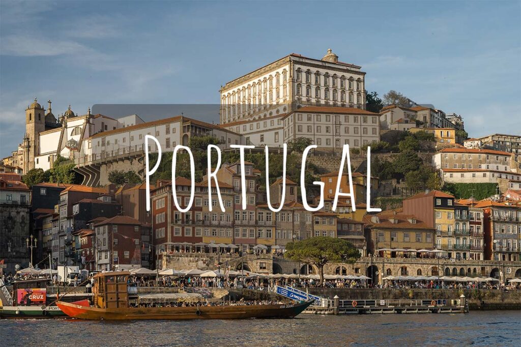 Panoramic view of Porto from the river. There's overlay text that reads Portugal.