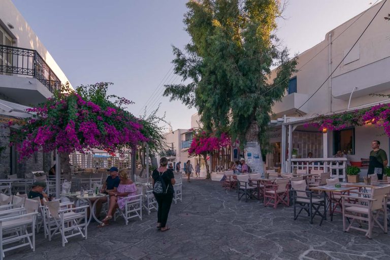 This is a photo of Antiparos Town. There are many cafes and brightly coloured bougainvilleas.