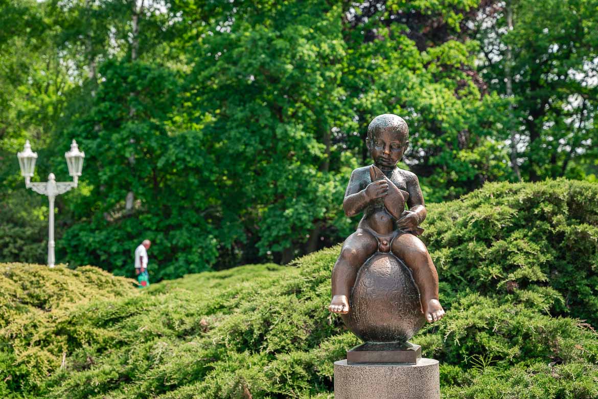 The little boy statue called Frantisek. The boy sits naked on a ball and is holding a fish.