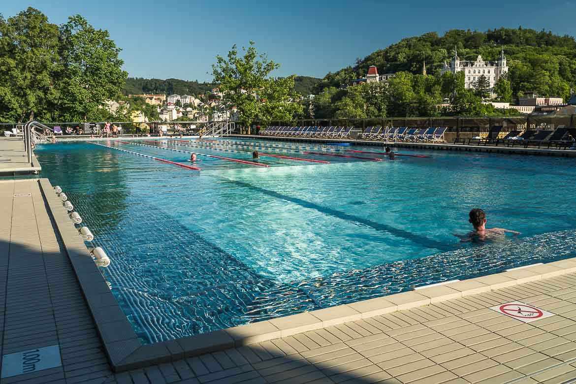 The swimming pool at the rooftop terrace of Hotel Thermal. In the background, panoramic views of Karlovy Vary. Spending an afternoon at the Thermal Hotel pool is one of the best things to do in Karlovy Vary. 