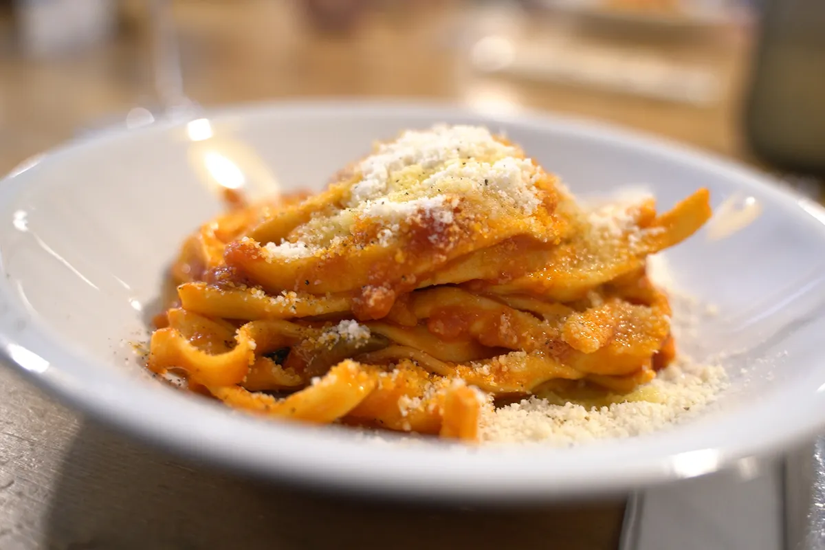 A close-up of a pasta alla puttanesca dish.