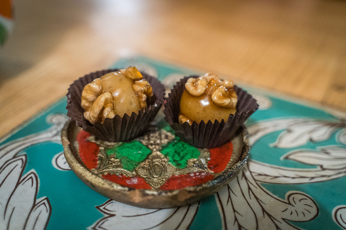 A close up of two Orbeliani candy topped with walnut halves. 