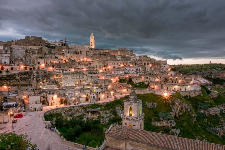 This photo shows a spectacular view of Matera at dusk. The street lights create a nativity scene effect.