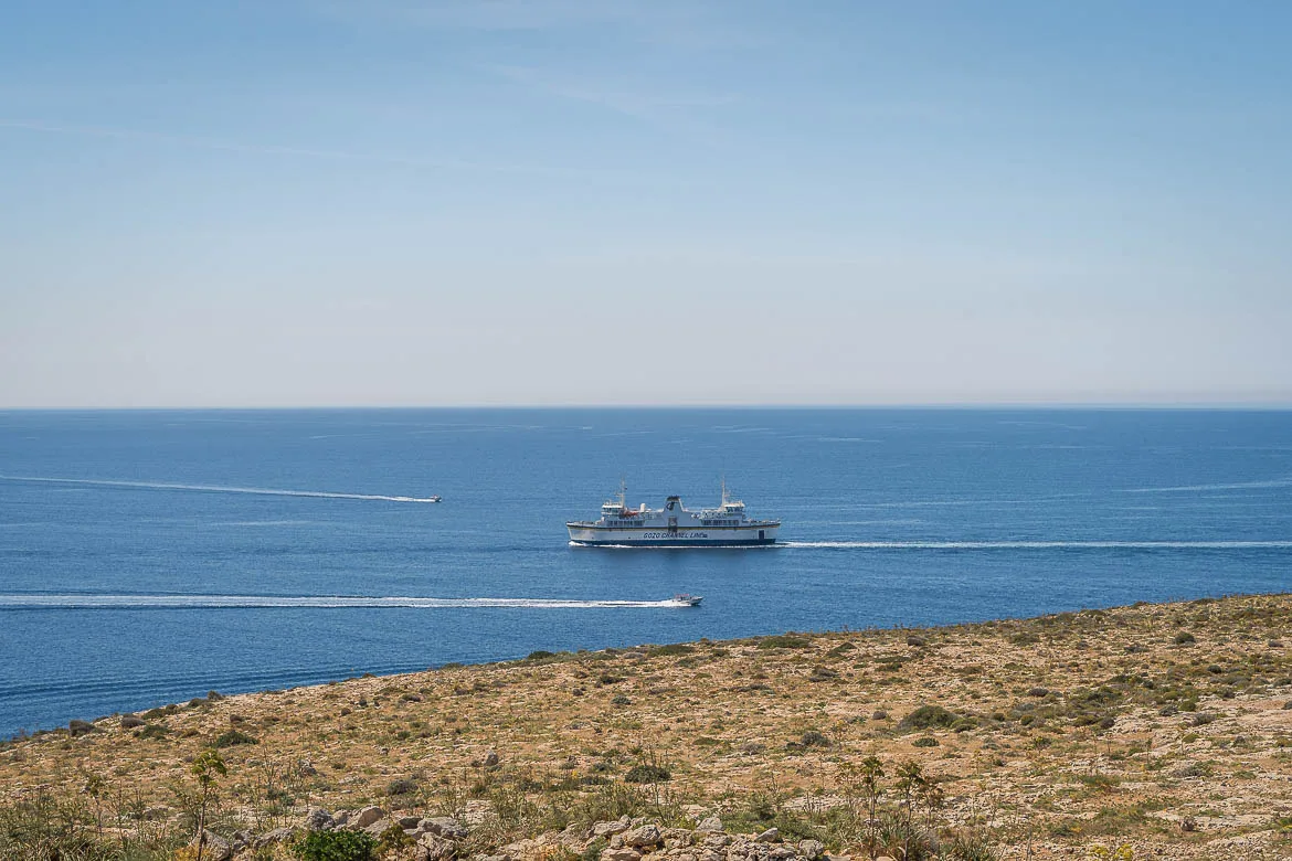 Panoramic view of one of the ferries crossing the Gozo Channel. Two small speedboats cross the chennel on the opposite direction.