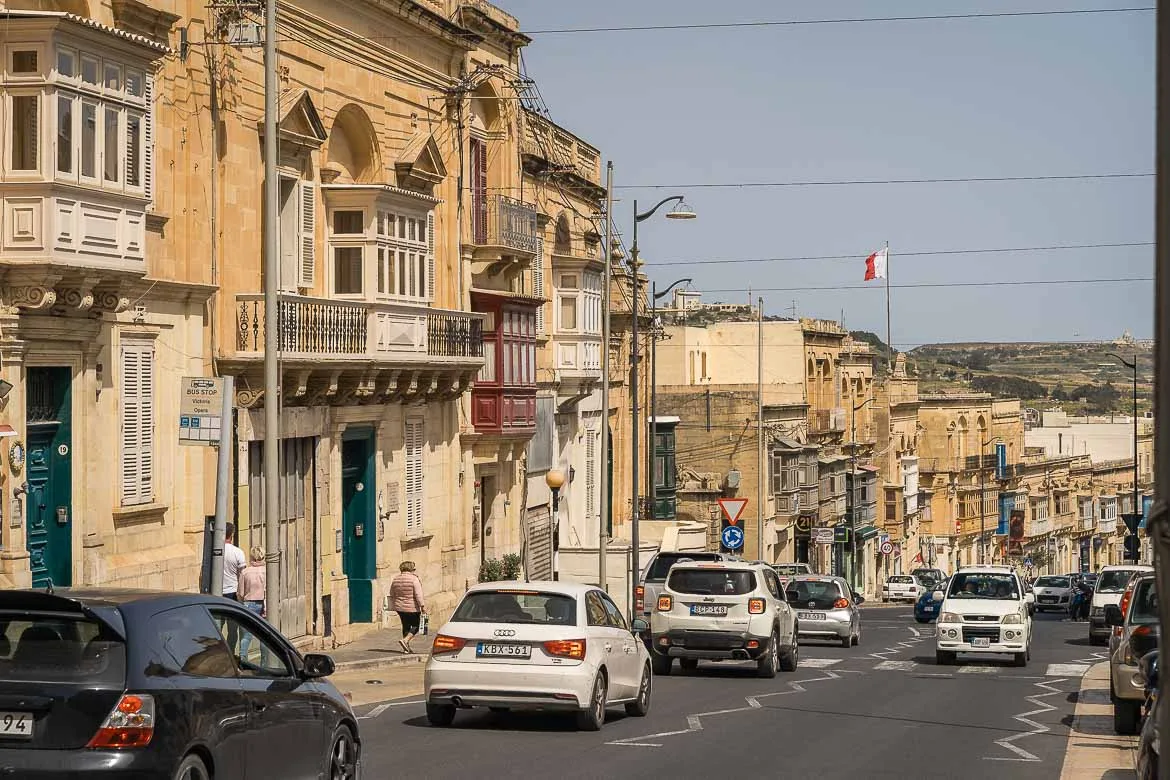 A street with traffic in Victoria. Vehicles are moving on the left lane.