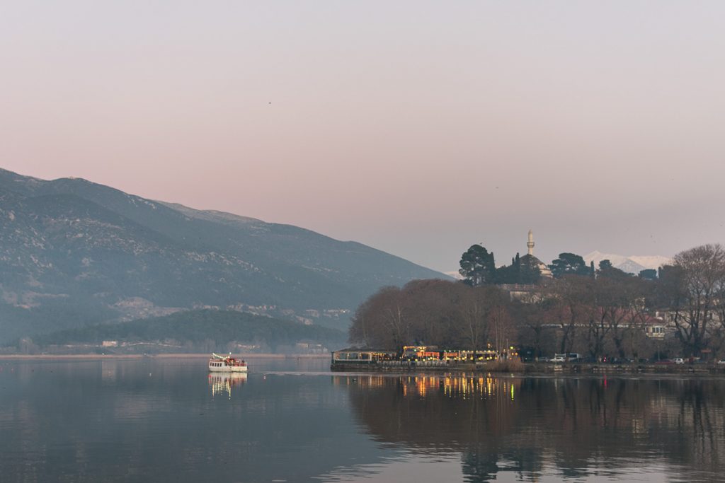 This is a panoramic shot of Ioannina Lake in the afternoon of a cold winter day. The ferry going to the island and the lights from cafes on the shore create perfect reflections on the tranquil waters. This photo shows the utter beauty of Ioannina city. This is why we set it as the featured image for the article: What to do in Ioannina Greece in winter.