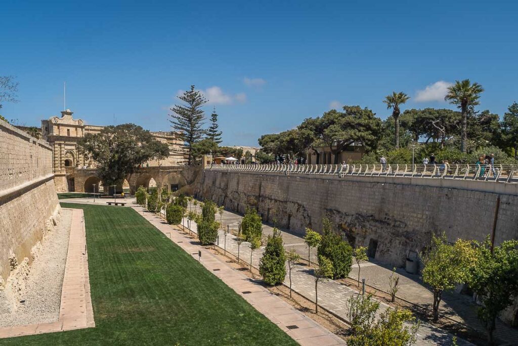 Panoramic view of the moat with the main gate and its bridge in the backdrop.