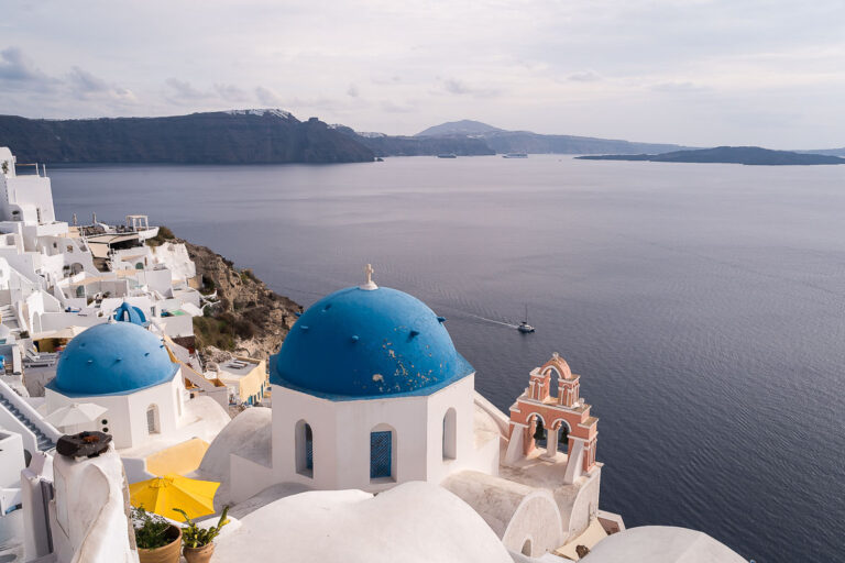 This image shows the iconic blue domes of Oia in Santorini